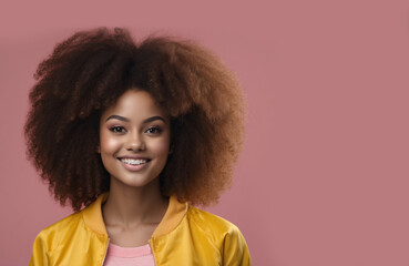 portrait of beautiful young woman with big afro smiling on pink background