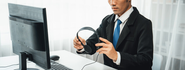 Business people wearing headset working in office to support remote customer or colleague. Call...