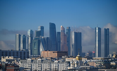 Fototapeta na wymiar January 7, 2023, Moscow, Russia. Clouds over the Moscow City office center building on a winter day