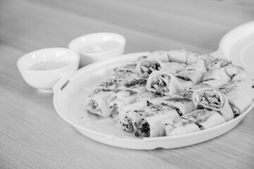 Black and white shawarma plate with dips