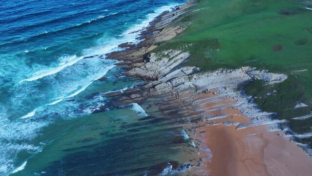 Colors and rock formations of El Sable beach. Coastal landscape in the town of Tagle. Aerial view from a drone. Suances Municipality. Cantabrian Sea. Cantabria. Spain. Europe