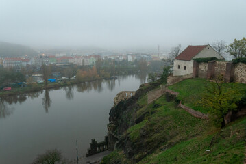 Fototapeta na wymiar The view from Vysehrad Castle of Libuse's Bath on a hill and morning fog over Prague, the Czech Republic