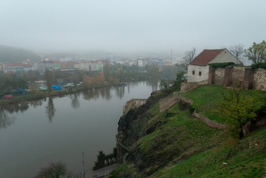 The view from Vysehrad Castle of Libuse's Bath on a hill and morning fog over Prague, the Czech Republic