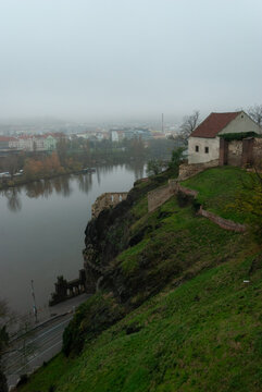 The view from Vysehrad Castle of Libuse's Bath on a hill and morning fog over Prague, the Czech Republic