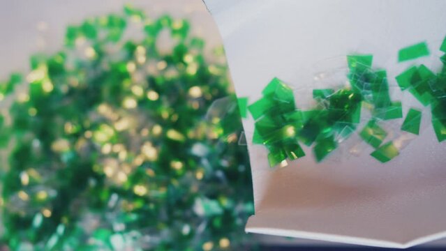 Recycling of household plastic. Small pieces of plastic move along the production line. Modern production.Close-up.