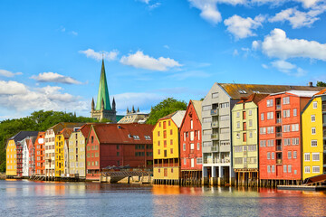 Old wooden houses  and Nidaros cathedral over Nidelva river in Trondheim, Norway - 665814050
