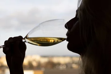 Fotobehang Woman drinking white wine, silhouette with glass © Algimantas