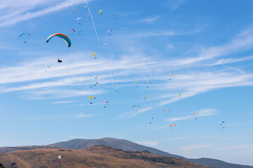 Numerous Paragliders Soaring Over the Serra da Estrela Mountains in Portugal