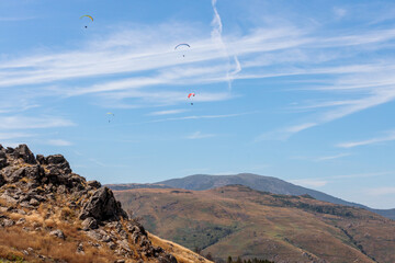 Numerous Paragliders Soaring Over the Serra da Estrela Mountains in Portugal