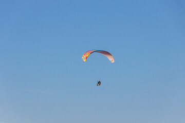 Paraglider Soaring in a Blue Sky