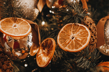 Creative Christmas tree decorations made from dried sliced oranges and mandarins. New Year winter...