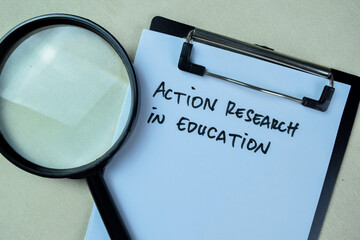 Concept of Action Research in Education write on paperwork isolated on Wooden Table.