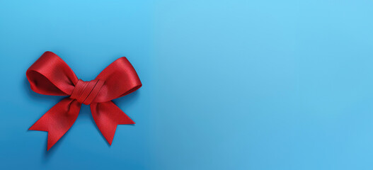 Red awareness ribbon for World AIDS Day on a textured blue background, promoting unity and support. Banner, place for text