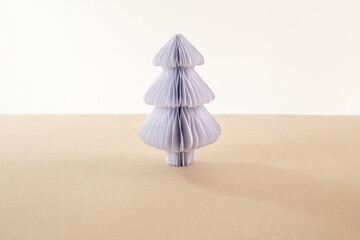 a paper christmas tree sitting on top of a table, single pine made from paper, 