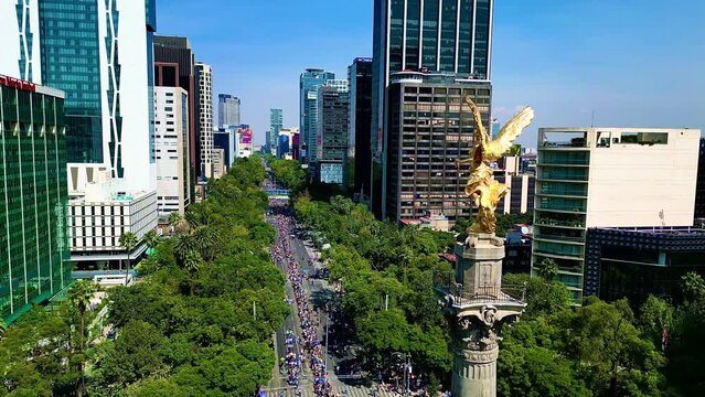 Aerial view from Mexico angel de la independencia monument in a festival dia de muertos parade, alebrijes art in reforma street