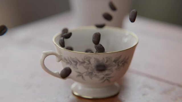 Coffee beans falling into a cup in slow motion