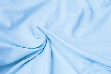 Light blue cotton bedsheets. Crumpled  sky blue natural linen fabric. Azure pastel powder color textile folds.