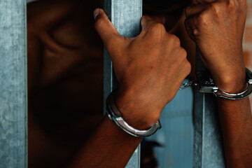 Handcuffed prisoners being arrested in a trial at the Court of Law and Justice Handcuffs of an...