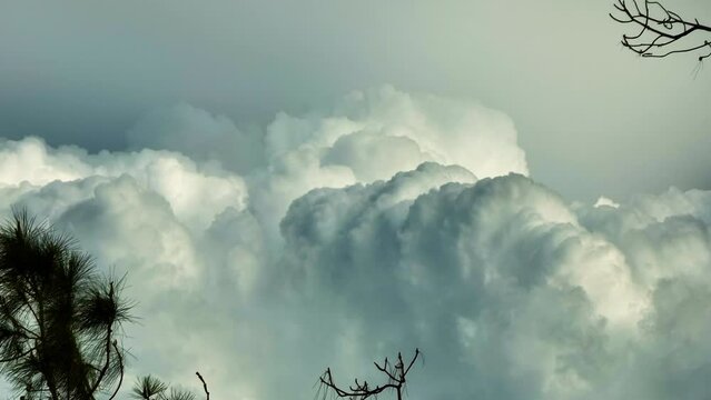 Time lapse of white fluffy cumulonimbus clouds forming before thunderstorm on summer blue sky. Moving and changing cloudscape weather
