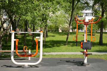 Empty outdoor gym with exercise machines in park