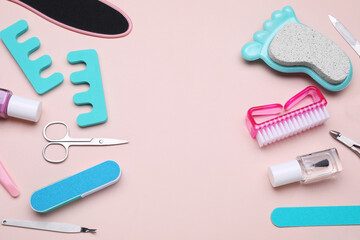 Set of pedicure tools on pink background, above view. Space for text