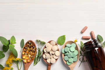 Different pills, herbs and flowers on white wooden table, flat lay with space for text. Dietary...