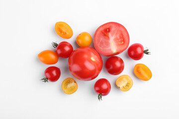 Flat lay composition with different whole and cut tomatoes on white background