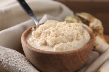 Spicy horseradish sauce in bowl on table, closeup