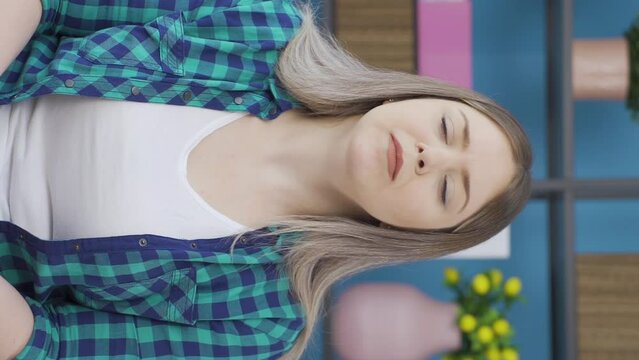 Vertical video of Sick woman with rapid breathing. The woman cannot control her breathing.