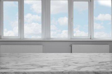 Empty white marble table against window indoors. Space for design