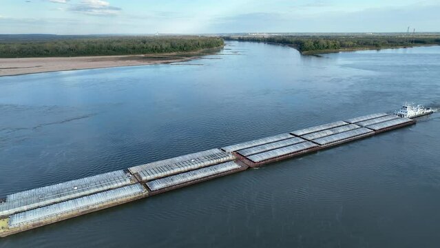 towboat with barges on the Mississippi River at confluence with the Missouri River below Alton, IL