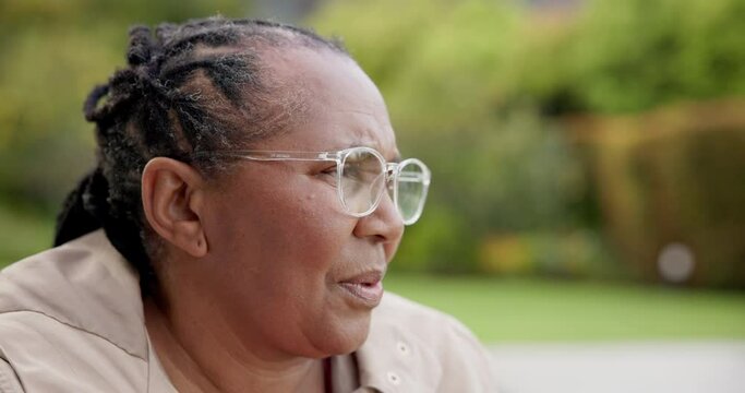 Senior woman, sad and mental health in garden in retirement village, sad memory and tired alone with fear. Black person, dementia or thinking with grief on face, frustrated and depression or anxiety
