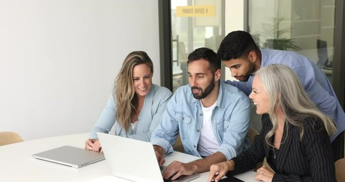 Group of multi-ethnic diverse office employees, friendly teammates working together using laptop, learn new software, corporate program, develop marketing strategy engaged in teamwork at workplace