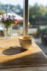 White Coffee cup on wooden table in cafe with lighting background