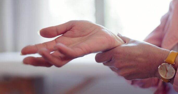 Injury, hands and senior woman with wrist pain, inflammation or strain with bruise, home or broken. Closeup, pensioner or elderly person massage with ache and arthritis with sprain or problem