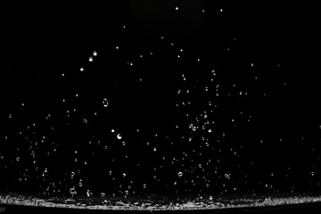 Shape form droplet of Water splashes into drop water attack fluttering in air. Splash Water for texture graphic resource elements, black background isolated selective focus blur - obrazy, fototapety, plakaty