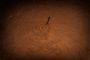 Halloween background on sandy beach near ocean in Patong, Phuket, Thailand with footprints, demons,...