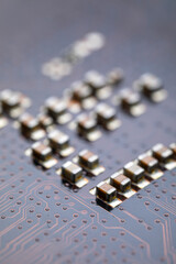 Macro closeup of a computer PCB motherboard backside. Tech science background. Electronic computer hardware technology.