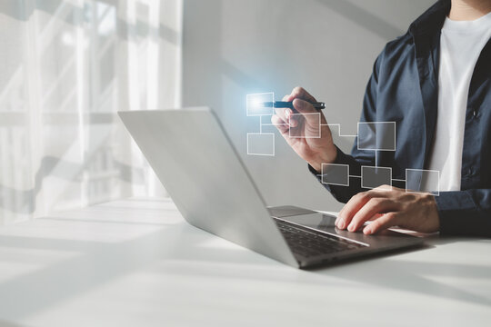 Person with hologram flowchart, businessman designing flowchart business workflow to systematically qualitatively, flowcharting to visualize the workflow of the program. Flowchart design concept.