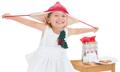 Digital png photo of happy caucasian girl with red hat and cookies on transparent background