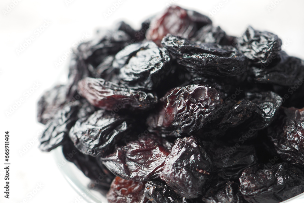Wall mural black raisin on white background, close up, - Wall murals