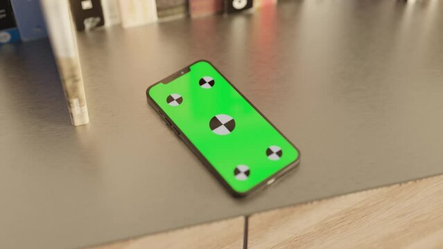 Smartphone with a Green Screen on the table with books