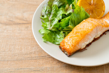 fried salmon steak with lemon and vegetable