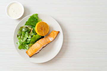 fried salmon steak with lemon and vegetable