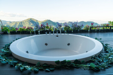 bath tub on balcony with mountain hill background