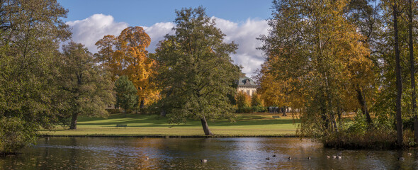 Park view on the island Drottningholm, a sunny colorful autumn day in Stockholm