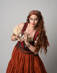 close up portrait of beautiful red haired woman wearing a medieval maiden, fortune teller costume....