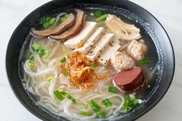 Vietnamese Rice Noodles Soup with Vietnamese Sausage served vegetables and crispy onion