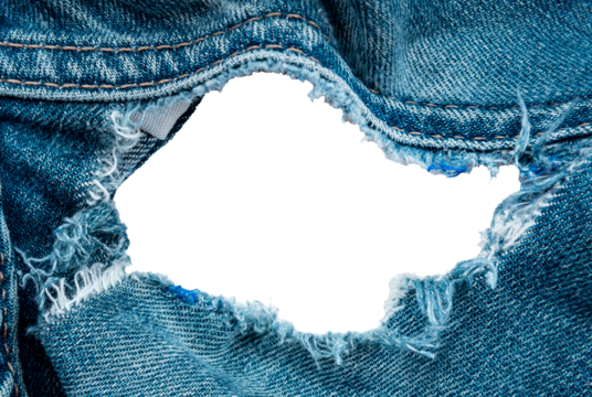 Hole in denim on a white background. Ripped jeans