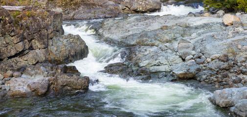 Rocks by the river in Canadian Nature Landscape. Background. Vancouver Island, BC, Canada